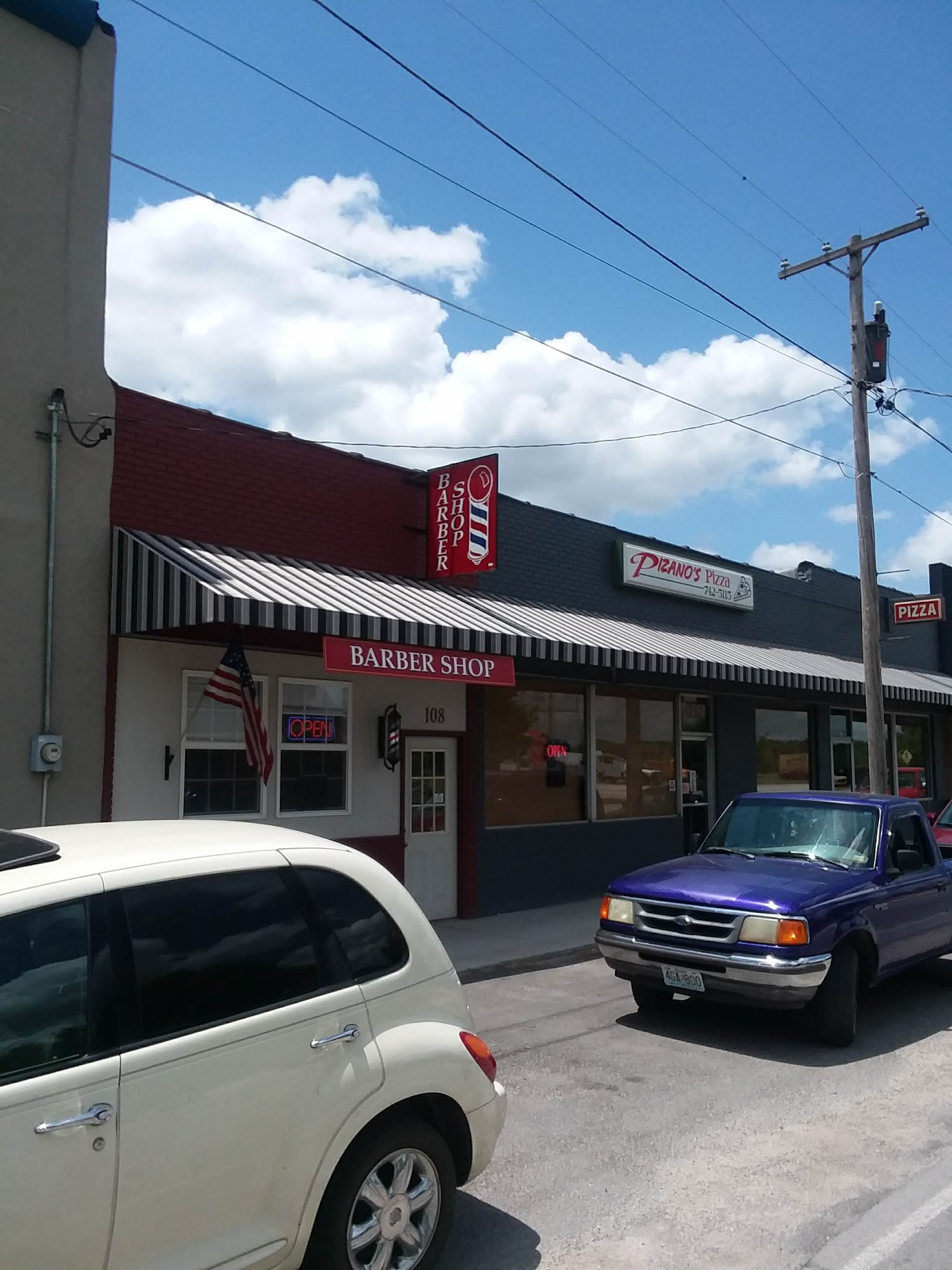 Street view showing the Willard Barber Shop exterior along East Jackson Street